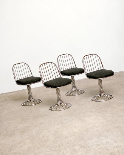Close-up of the table's pedestal base showing the tubular chrome construction.