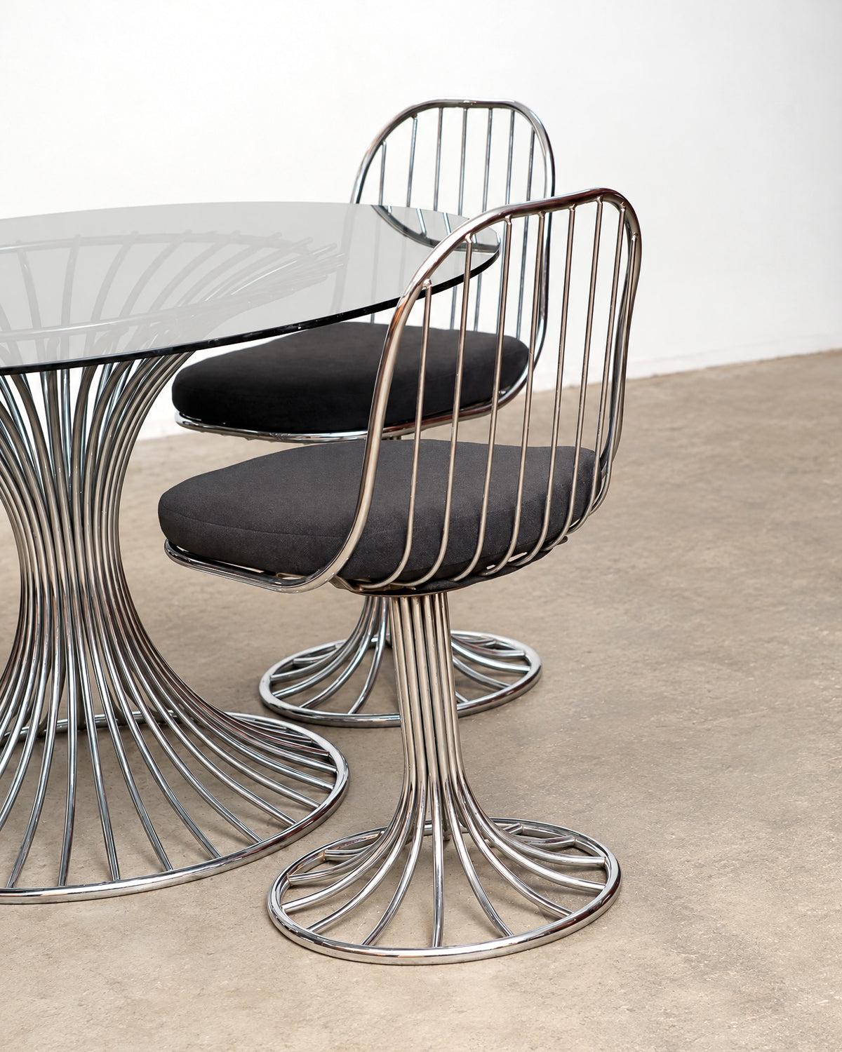 Detail of the chrome tubing where it meets the round chair base.