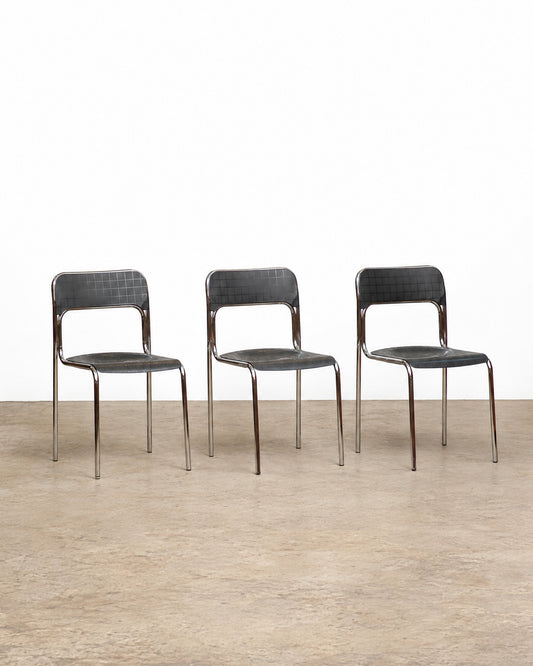 Three Cortina chrome chairs lined up against a plain white background.