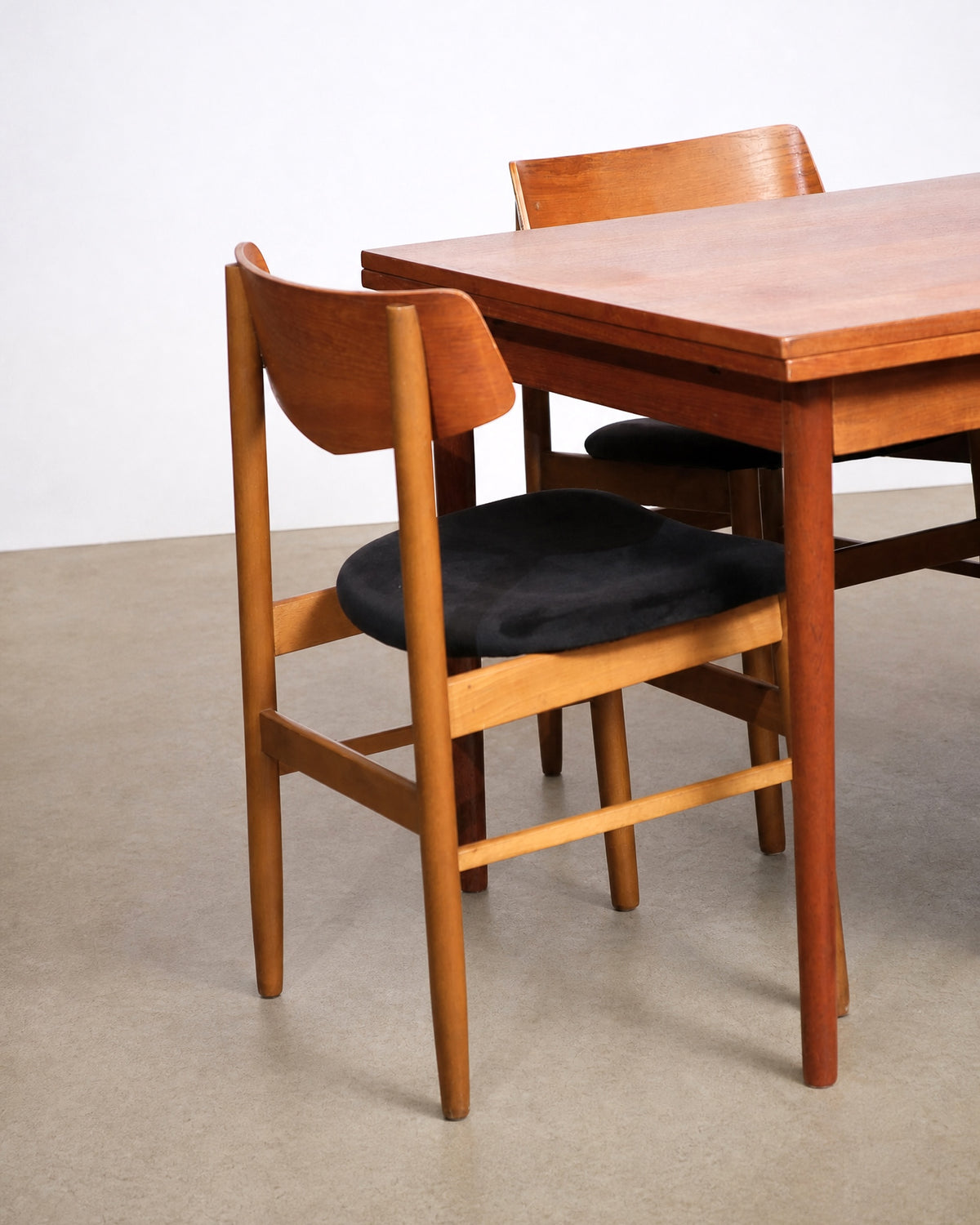 Group of four chairs arranged around the table from a slightly elevated angle.