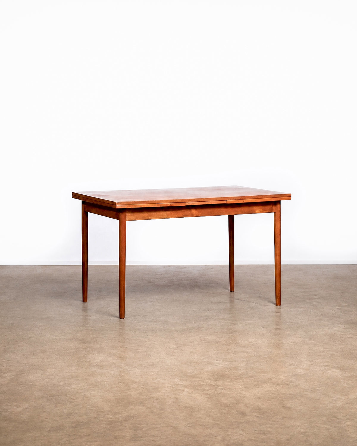 View of the slightly different chair among the set, showing its unique back design.