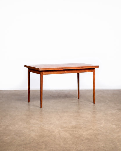 View of the slightly different chair among the set, showing its unique back design.