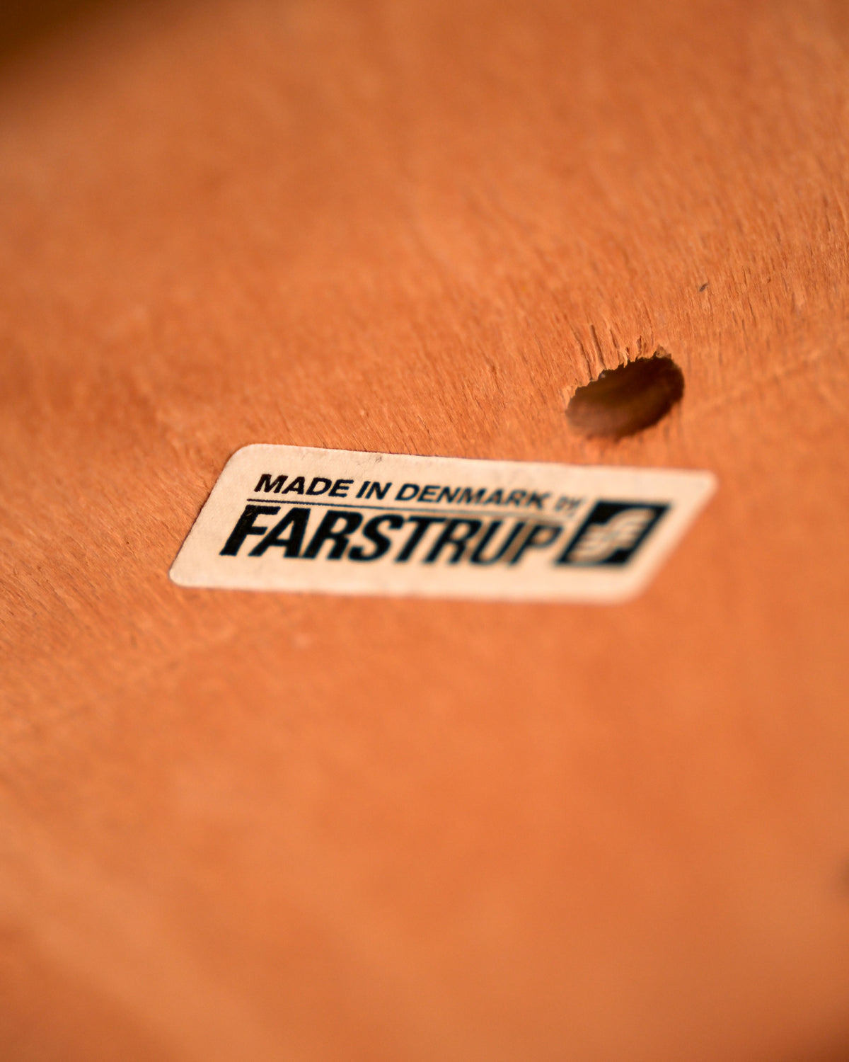 Close-up of the Farstrup 'Made in Denmark' label on the underside of the table.