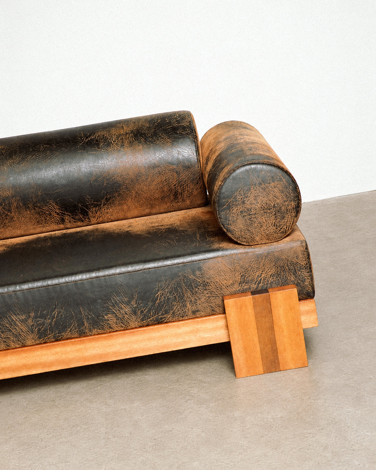 Wide view of the distressed leather sofa within the showroom, showing scale and proportions.