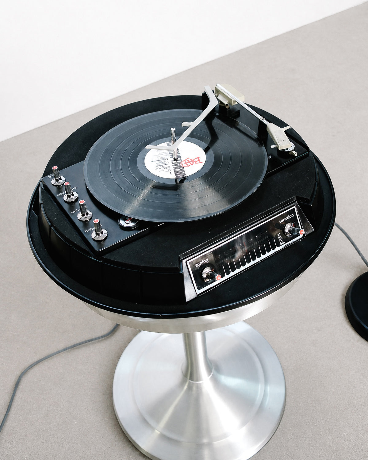 Detail of one of the matching pill-shaped speakers on its slender black stand.