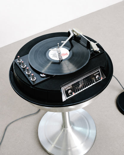 Detail of one of the matching pill-shaped speakers on its slender black stand.