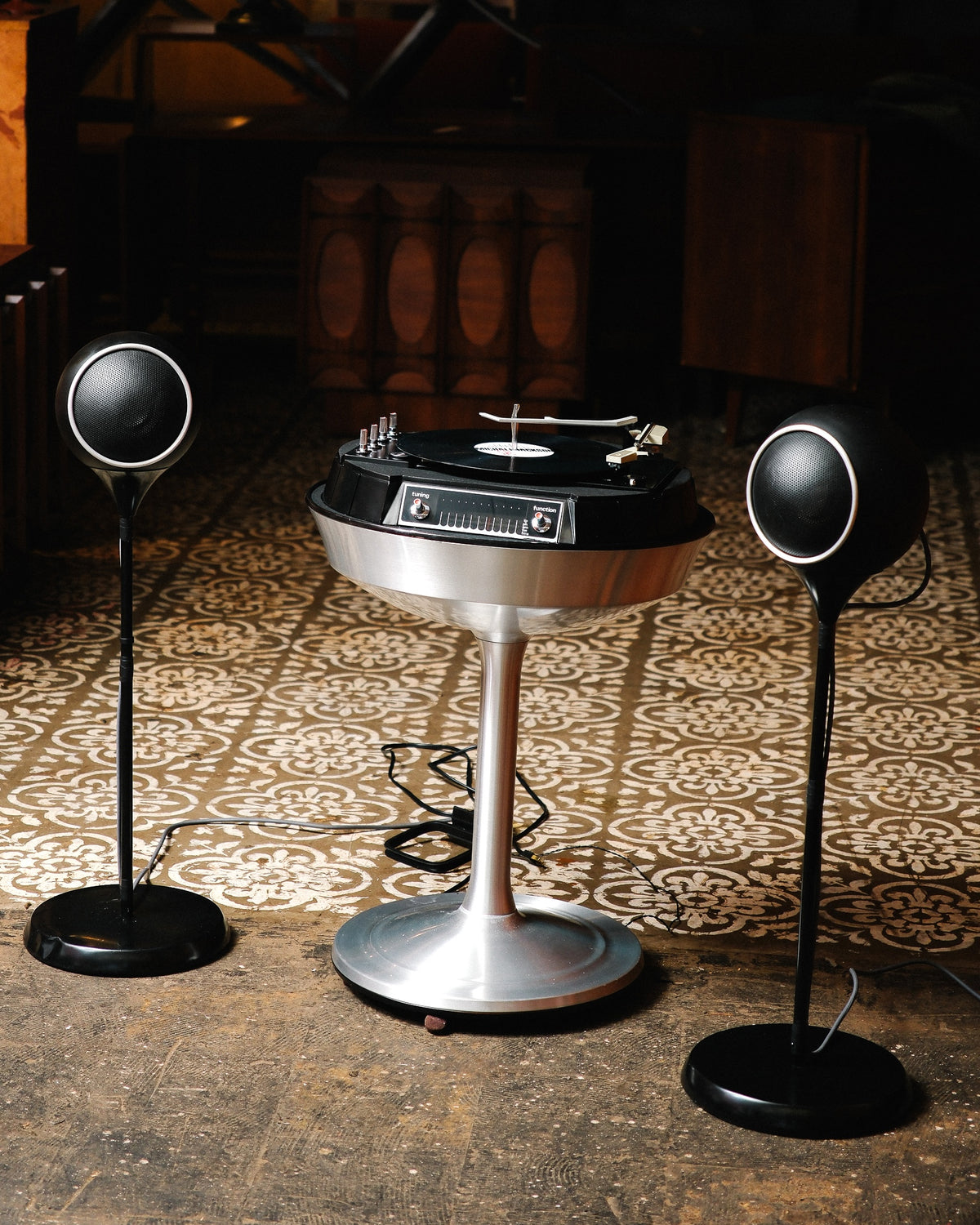 The Electrohome 711 Saturn on its pedestal base, flanked by two matching pill-shaped speakers on stands.