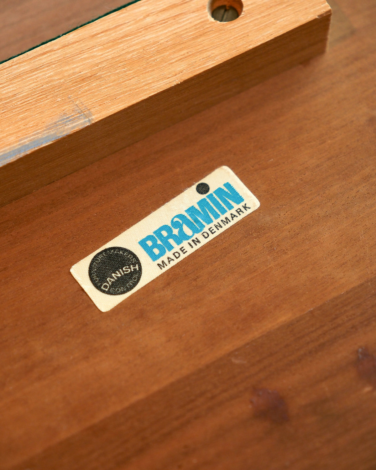 Close-up of the Bramin Danish furniture makers control label, made in Denmark, on the underside of the table top.