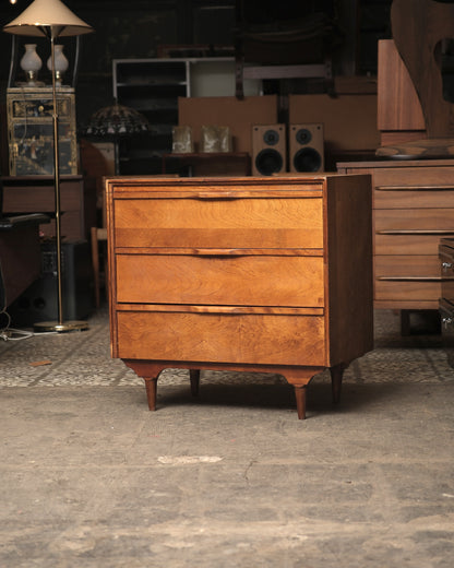 Front angled view of the mid-century modern 3-drawer dresser in a showroom setting.