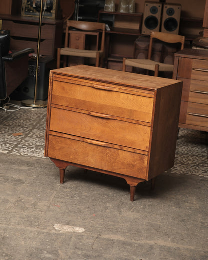 Three-quarter view of the dresser showing drawer pulls and tapered legs.