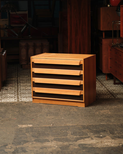 Front angled view of the mid-century modern 4-drawer dresser in a showroom setting