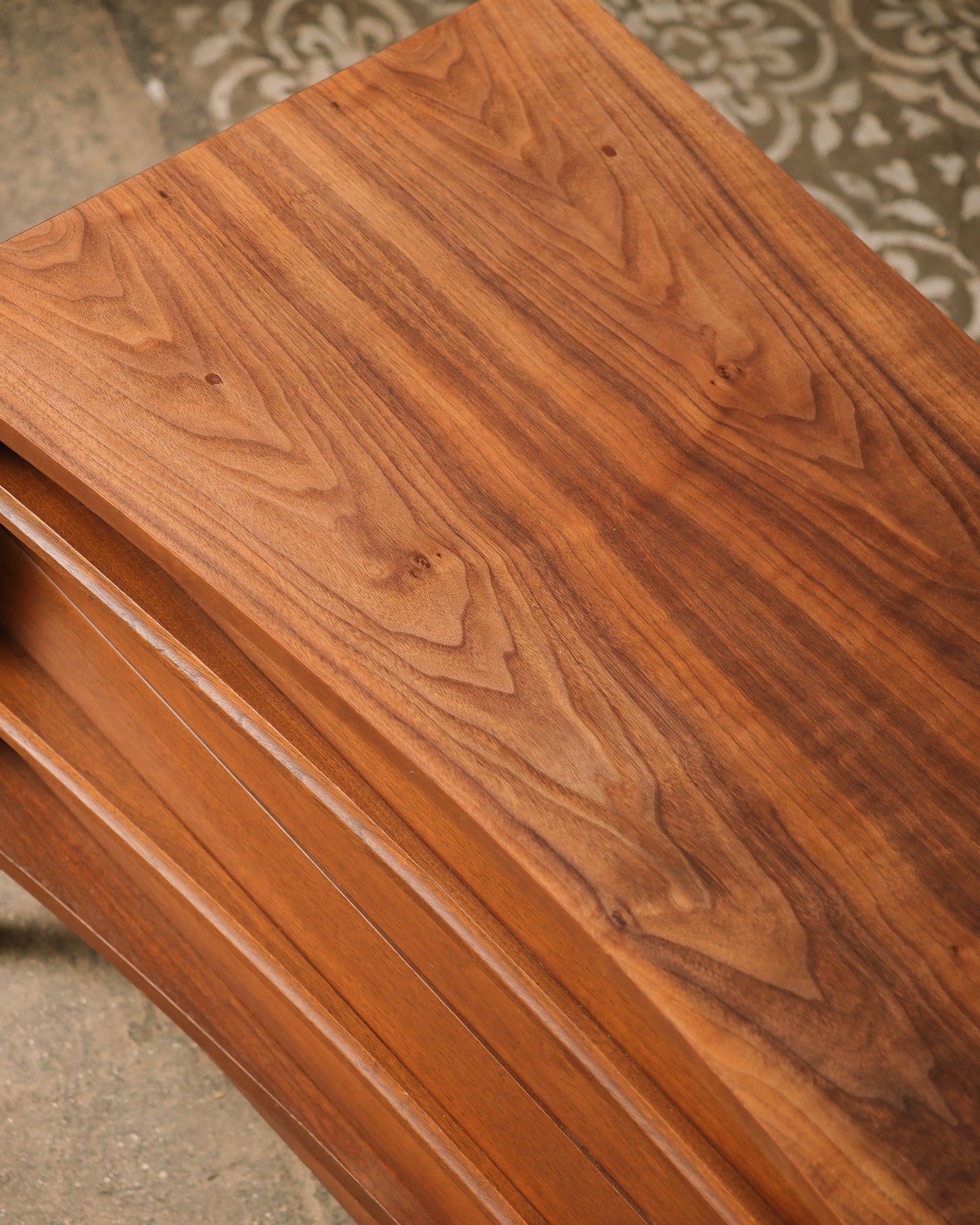 Close-up of a wooden surface with a rich, dark brown finish.