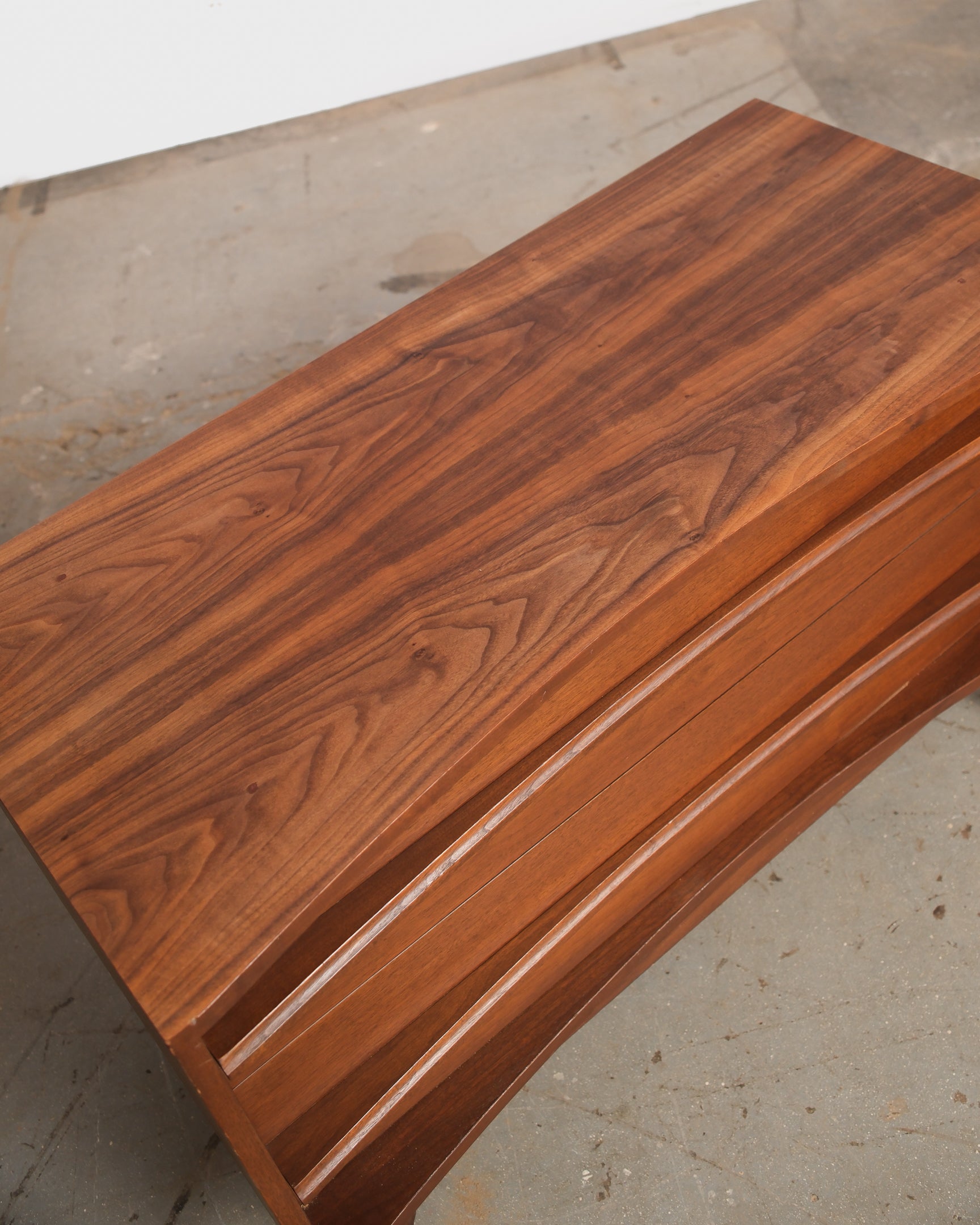 Wooden surface with a polished finish on a concrete floor