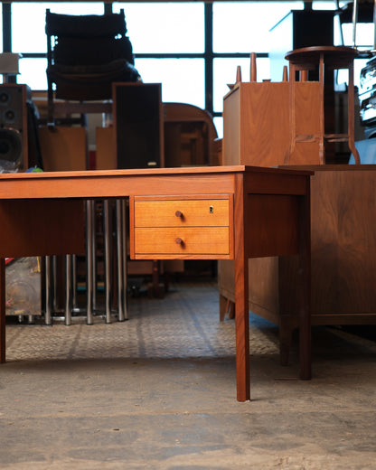Close-up side angle of the two-drawer unit with round wood pulls and brass keyhole escutcheon.