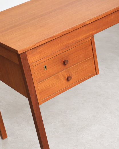 Overhead angle showing the drawer fronts, wood grain, and knob hardware in detail.