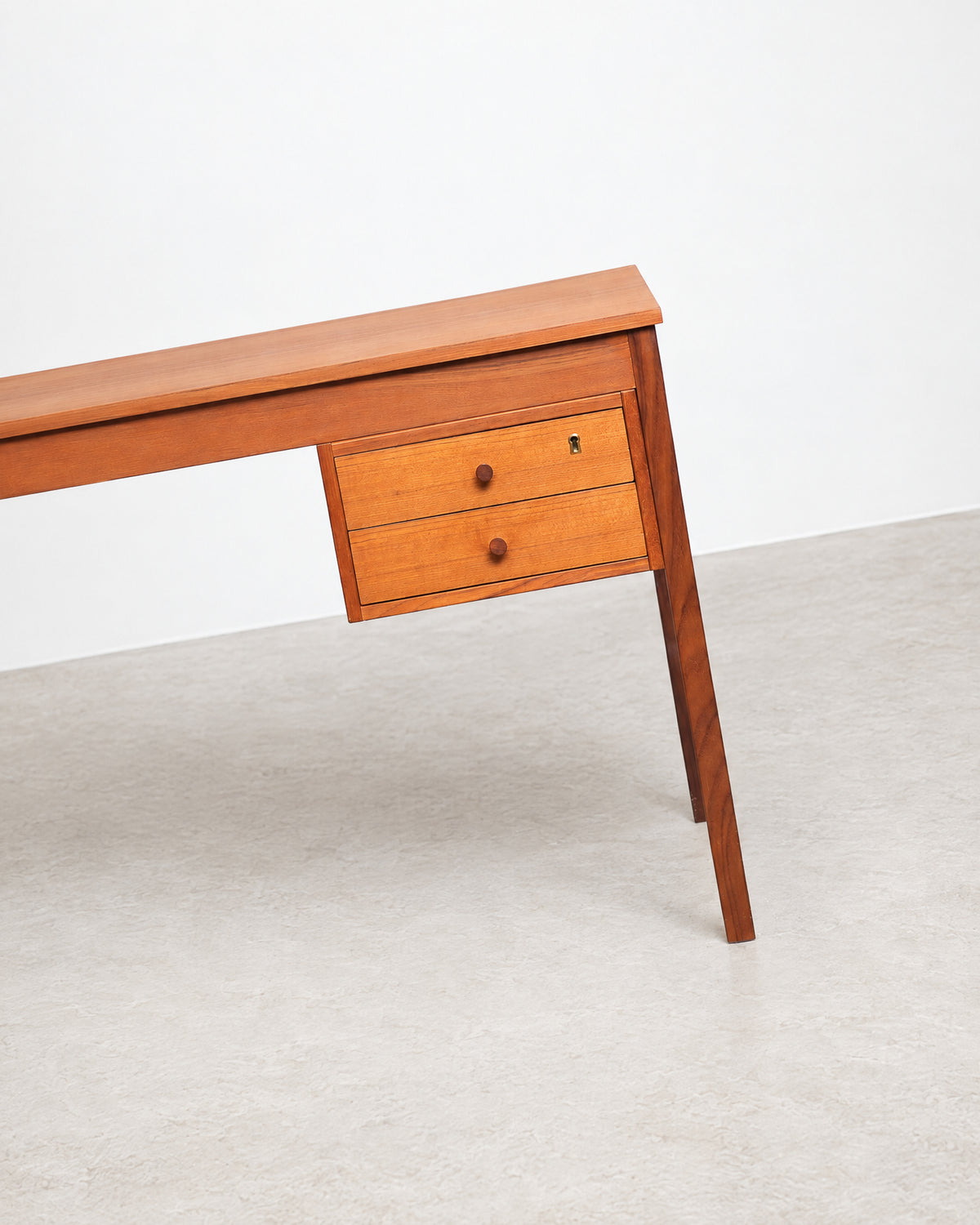 Close-up of the desk's wood grain and joinery detail.