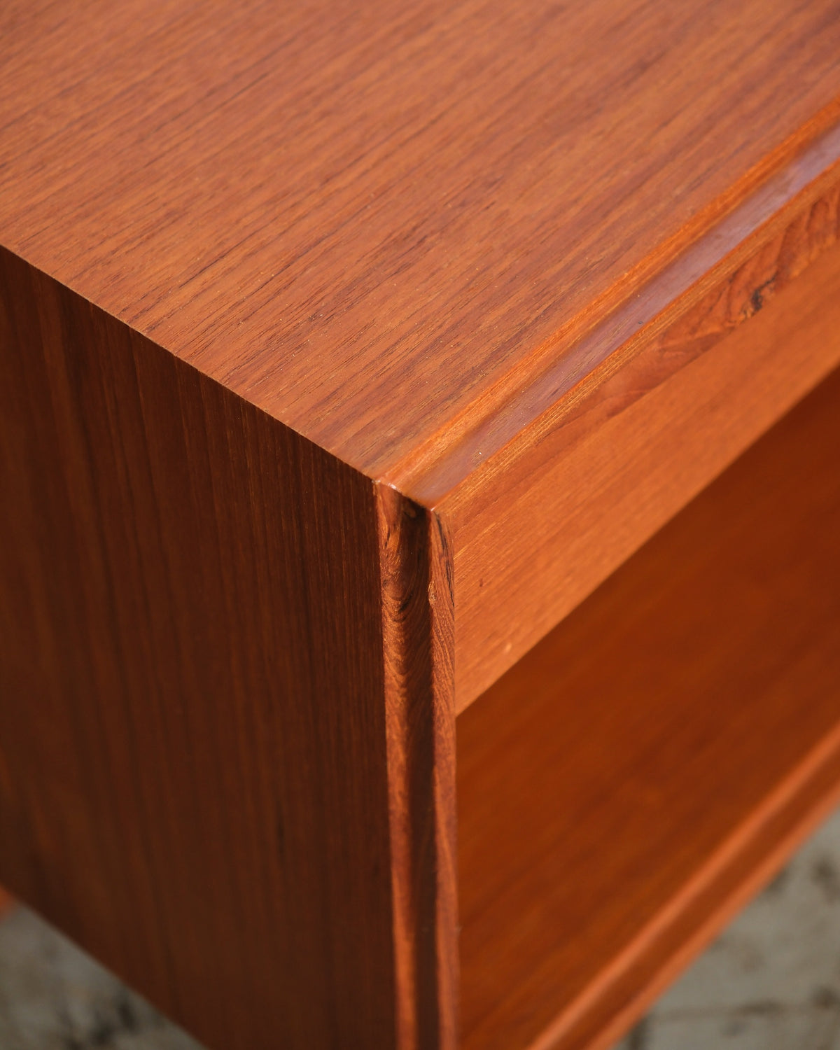 Close-up of the teak corner joinery and top edge finish on the nightstand