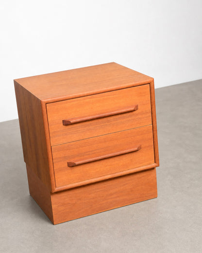 Wooden nightstand with two drawers on a neutral background