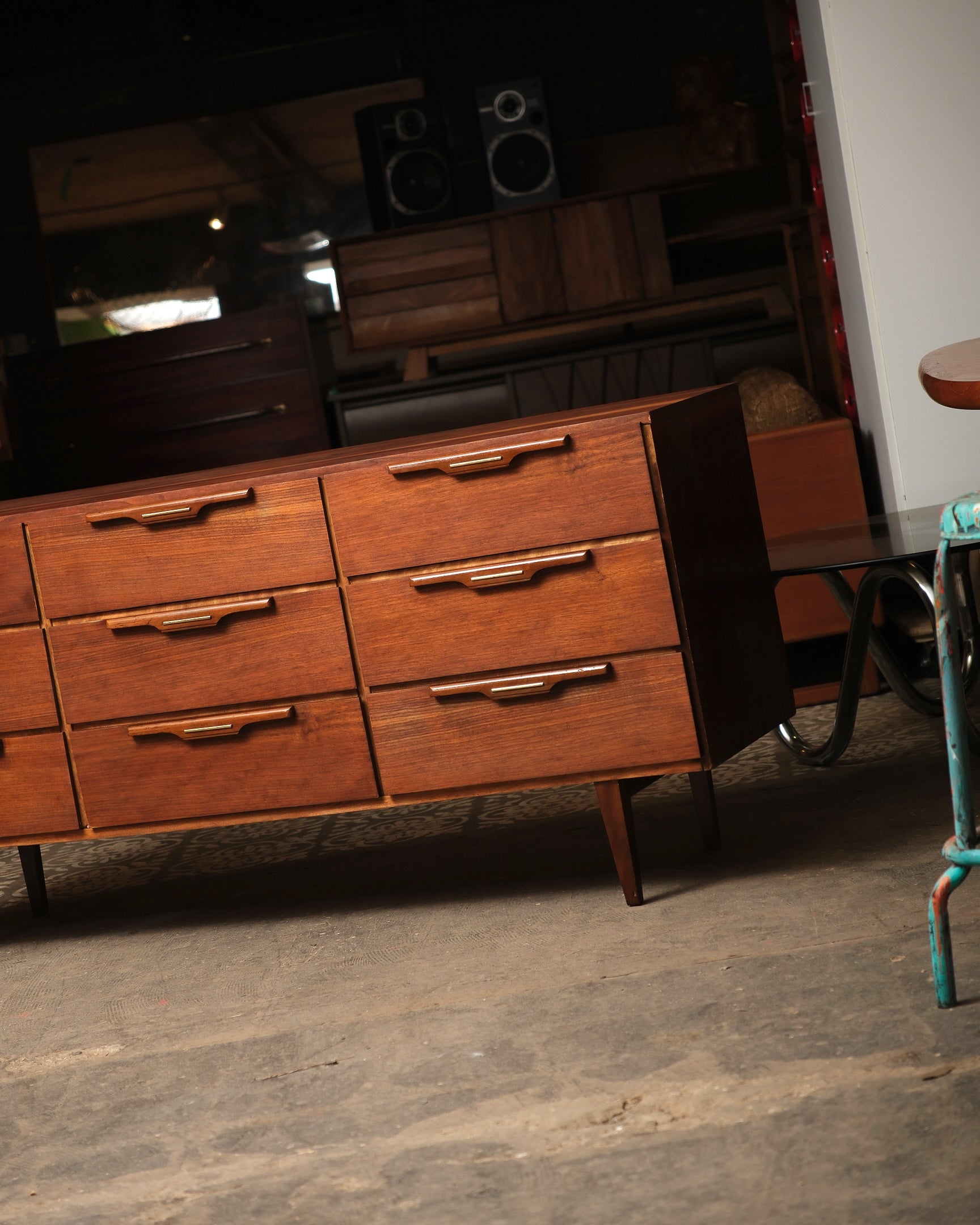 Wooden dresser with multiple drawers in a room setting