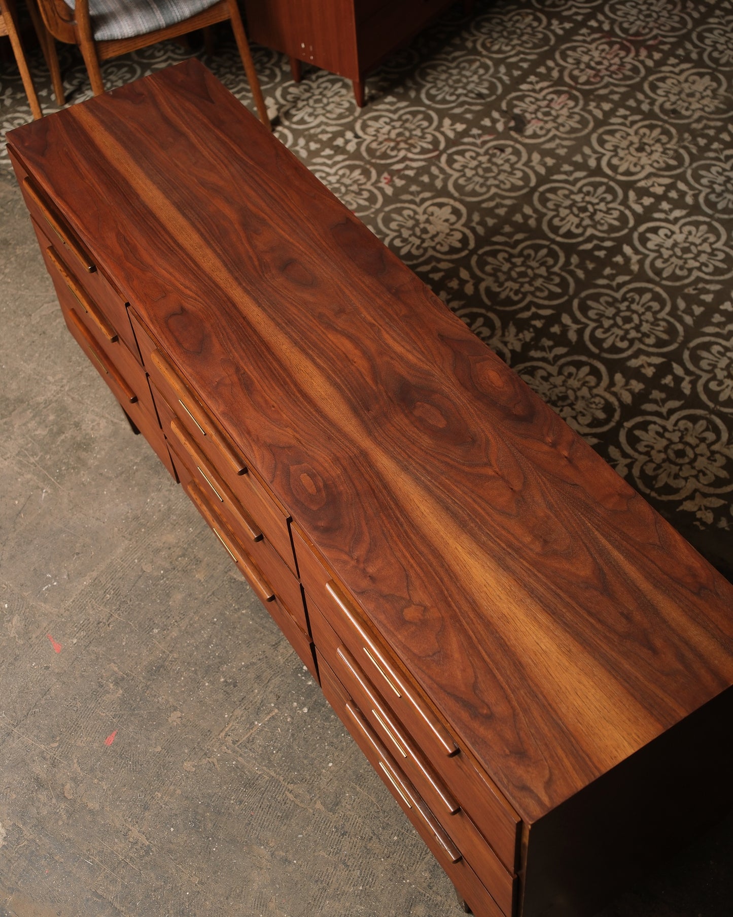 Wooden dresser with a patterned floor in the background