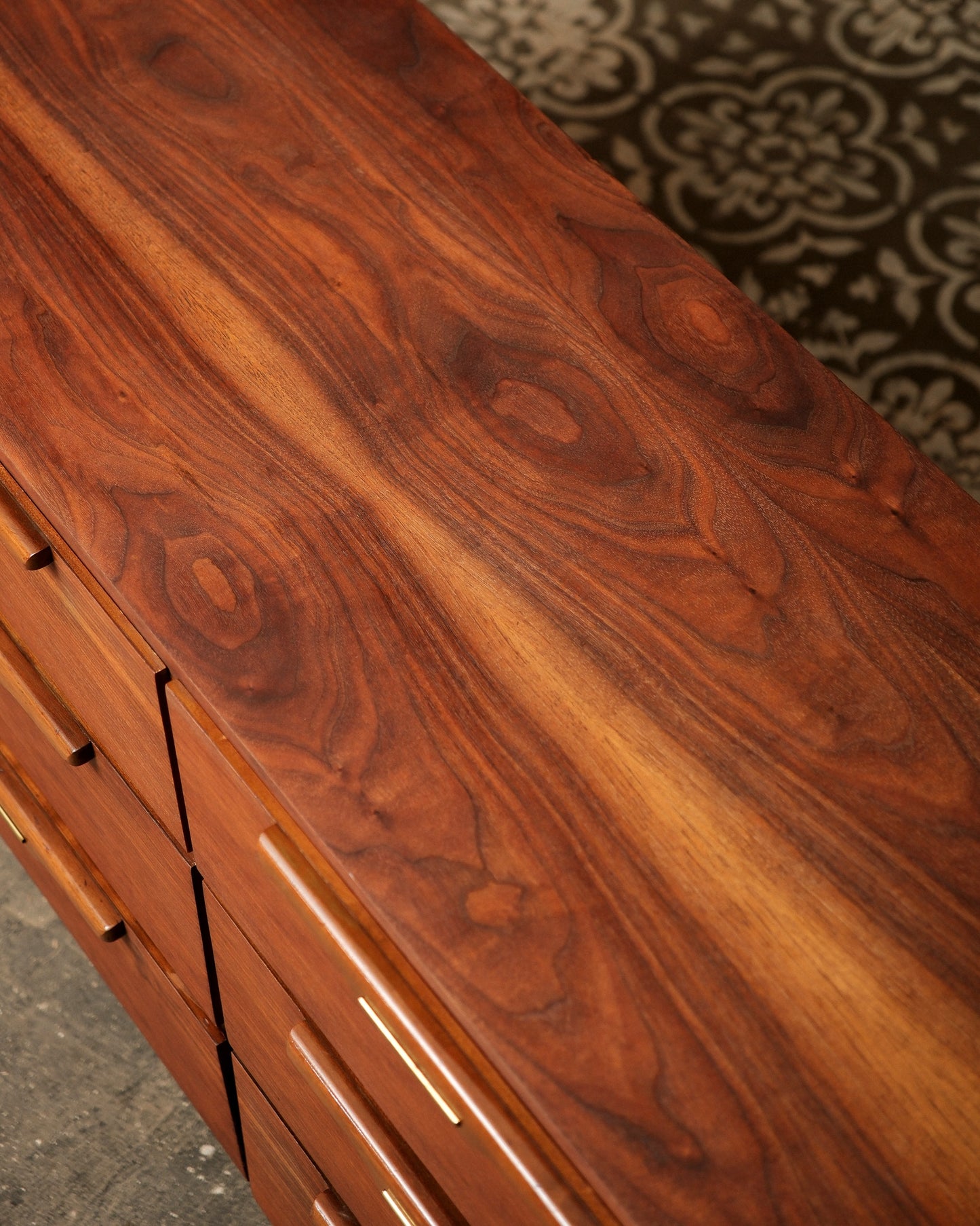Close-up of a wooden dresser with a focus on the grain and texture.