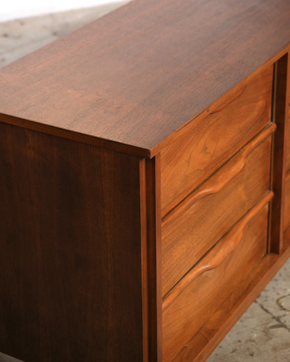 Close-up of the top corner and drawer front detail showing walnut grain and joinery
