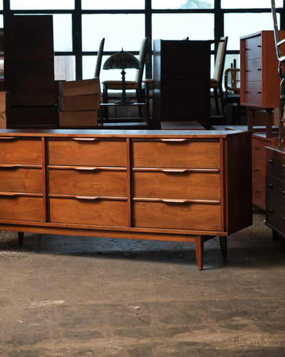 Side angle view showing the full length of the dresser and tapered legs