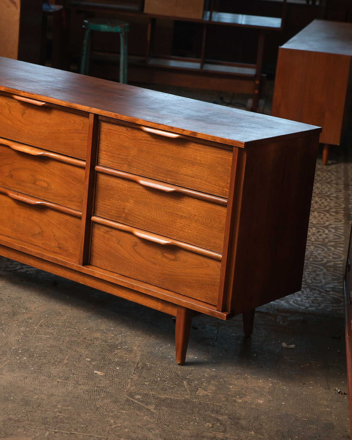 Elevated angle showing the top surface and sculpted drawer pulls