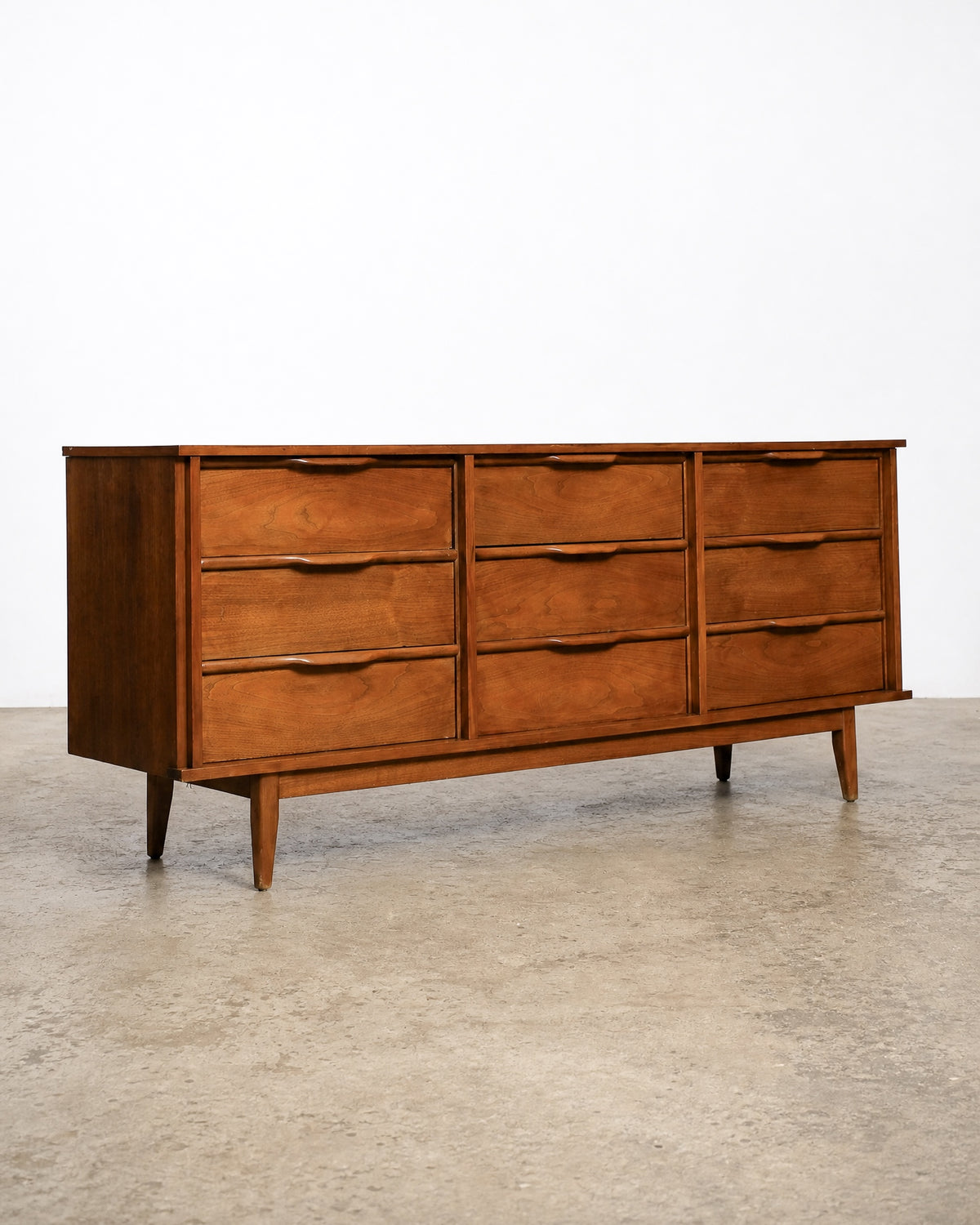 Wide shot showing the dresser among other vintage furniture pieces