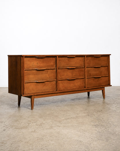 Wide shot showing the dresser among other vintage furniture pieces