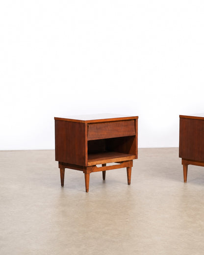 Side angle of one dark walnut nightstand with the second nightstand partially visible beside it.