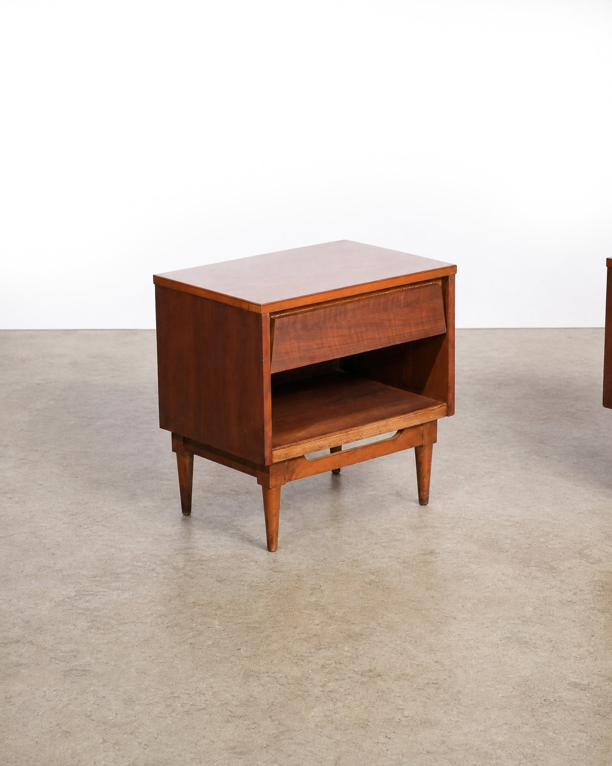 Additional angle of the nightstand showing the open lower shelf and leg detail.