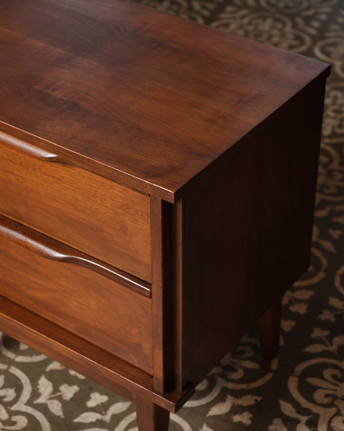 Close-up of the top corner showing wood grain, dovetail joinery, and drawer construction.