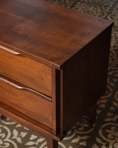 Close-up of the top corner showing wood grain, dovetail joinery, and drawer construction.