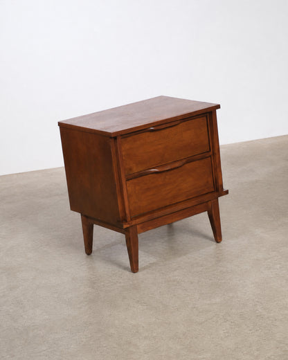 Full view of the nightstand from a slight angle against the showroom floor.