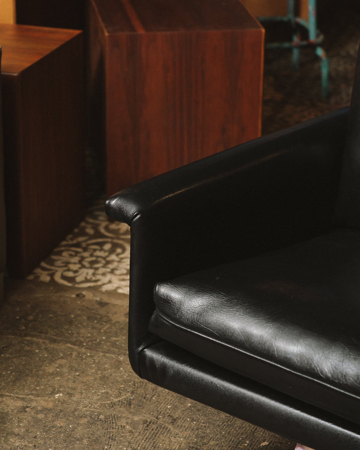 Close-up of the leather armrest and seat cushion showing texture and stitching detail.
