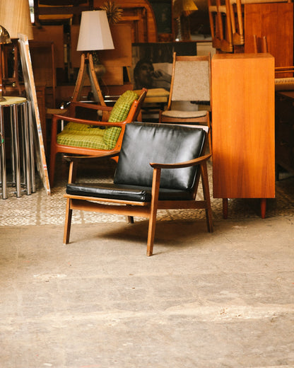 The lounge chair staged in the showroom among other vintage mid-century pieces.