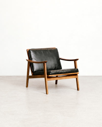 Rear angle of the lounge chair highlighting the frame construction and cushion placement.