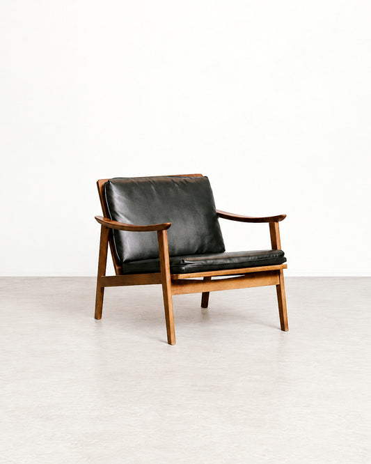Rear angle of the lounge chair highlighting the frame construction and cushion placement.
