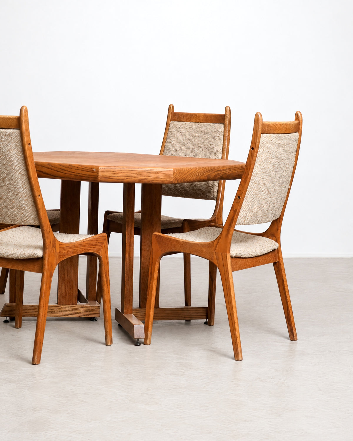 Side view of the dining set showing three chairs and the table's octagonal top and base.