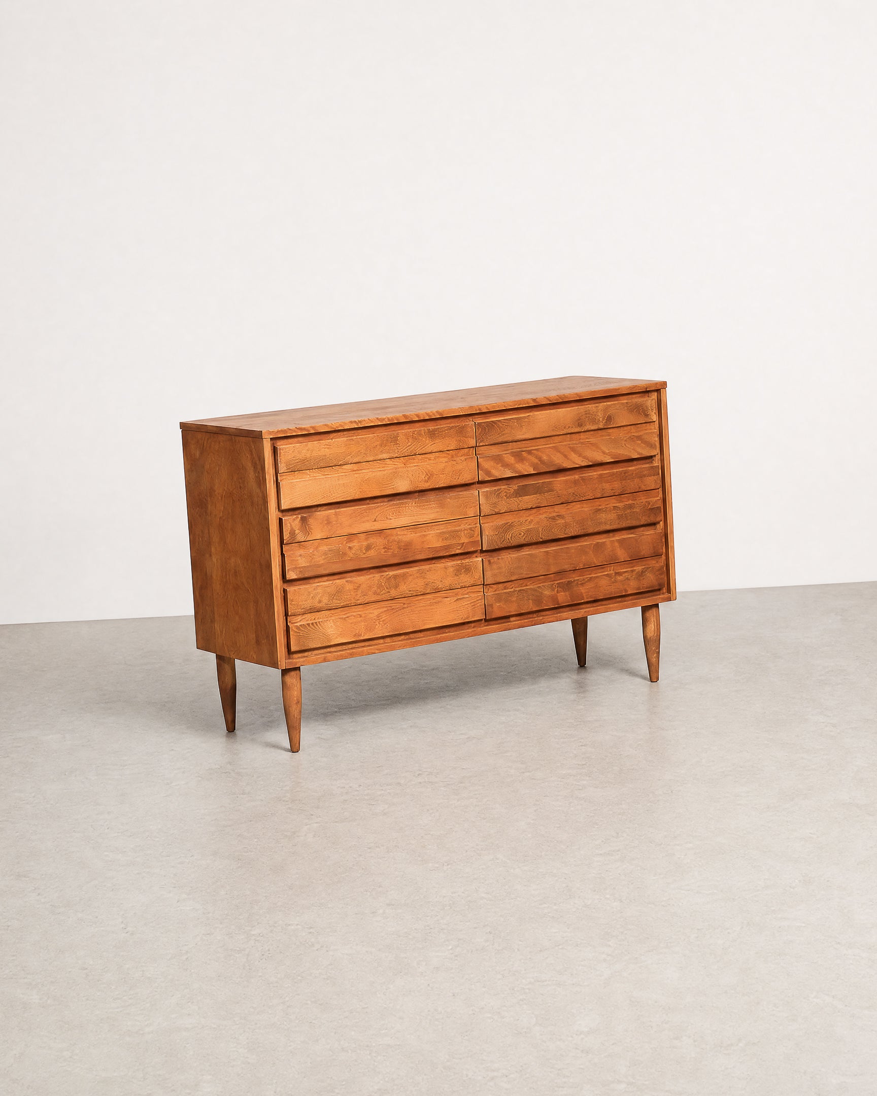 Wooden dresser with multiple drawers on a plain background