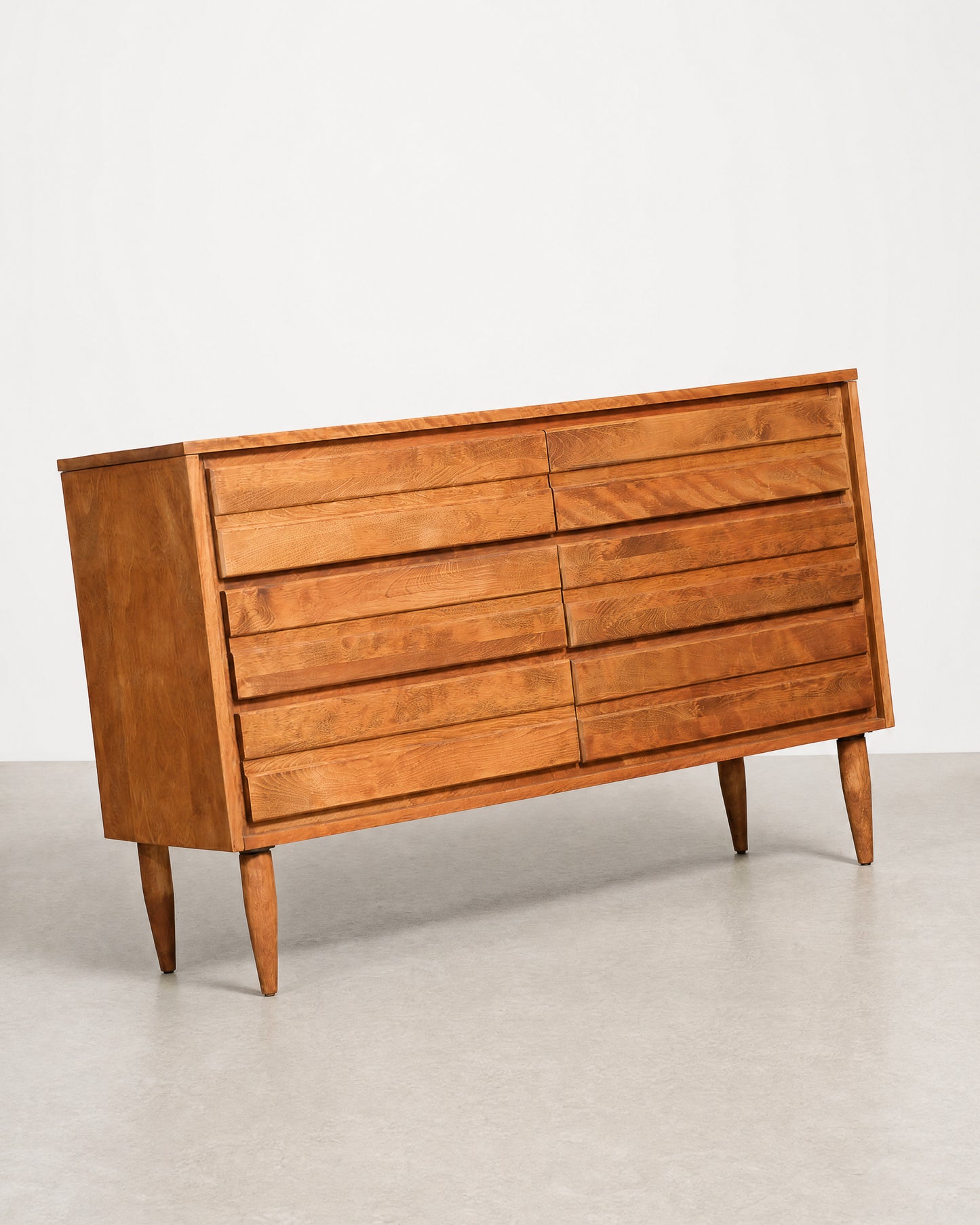 Wooden dresser with multiple drawers on a plain background