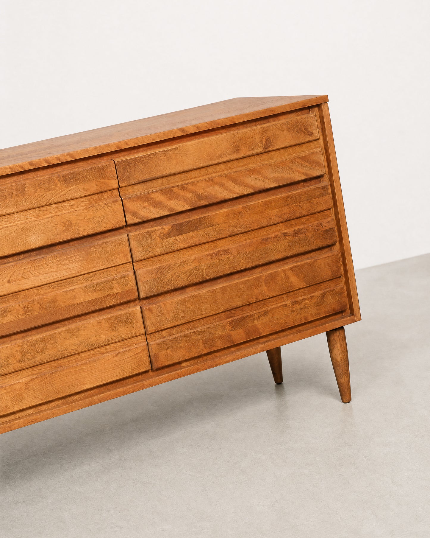 Wooden dresser with six drawers on a light gray floor and white background