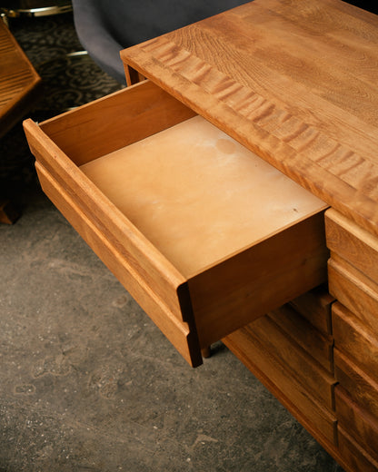 Wooden drawer with a textured surface on a concrete floor
