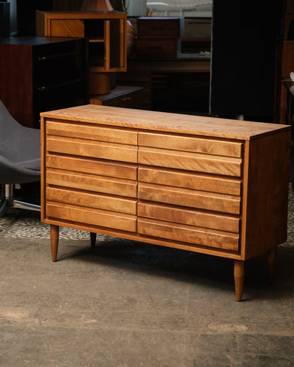 Wooden dresser with multiple drawers in a room setting