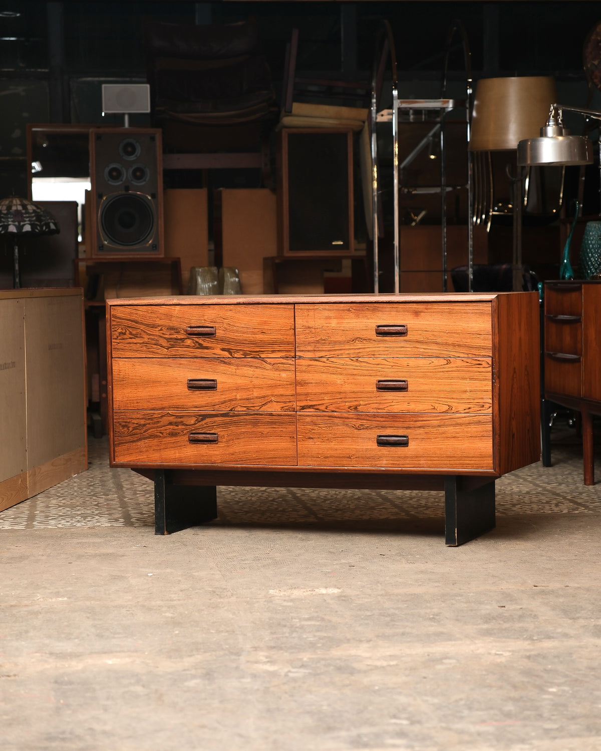 Mid-century modern rosewood 6-drawer dresser, front view showing bold grain and angled black metal legs.