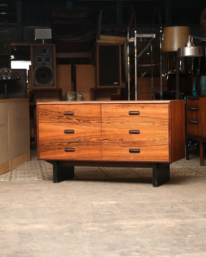 Mid-century modern rosewood 6-drawer dresser, front view showing bold grain and angled black metal legs.