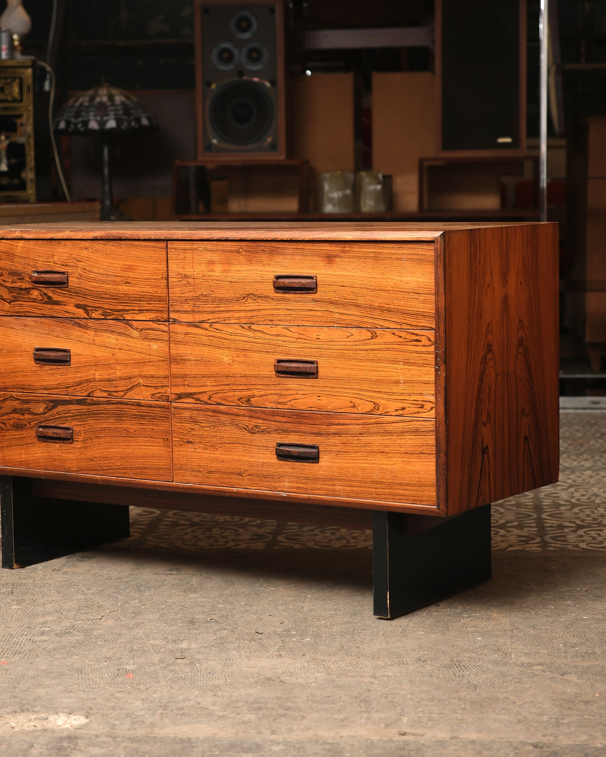 Angled view of the dresser highlighting the side panel grain and black metal leg detail.