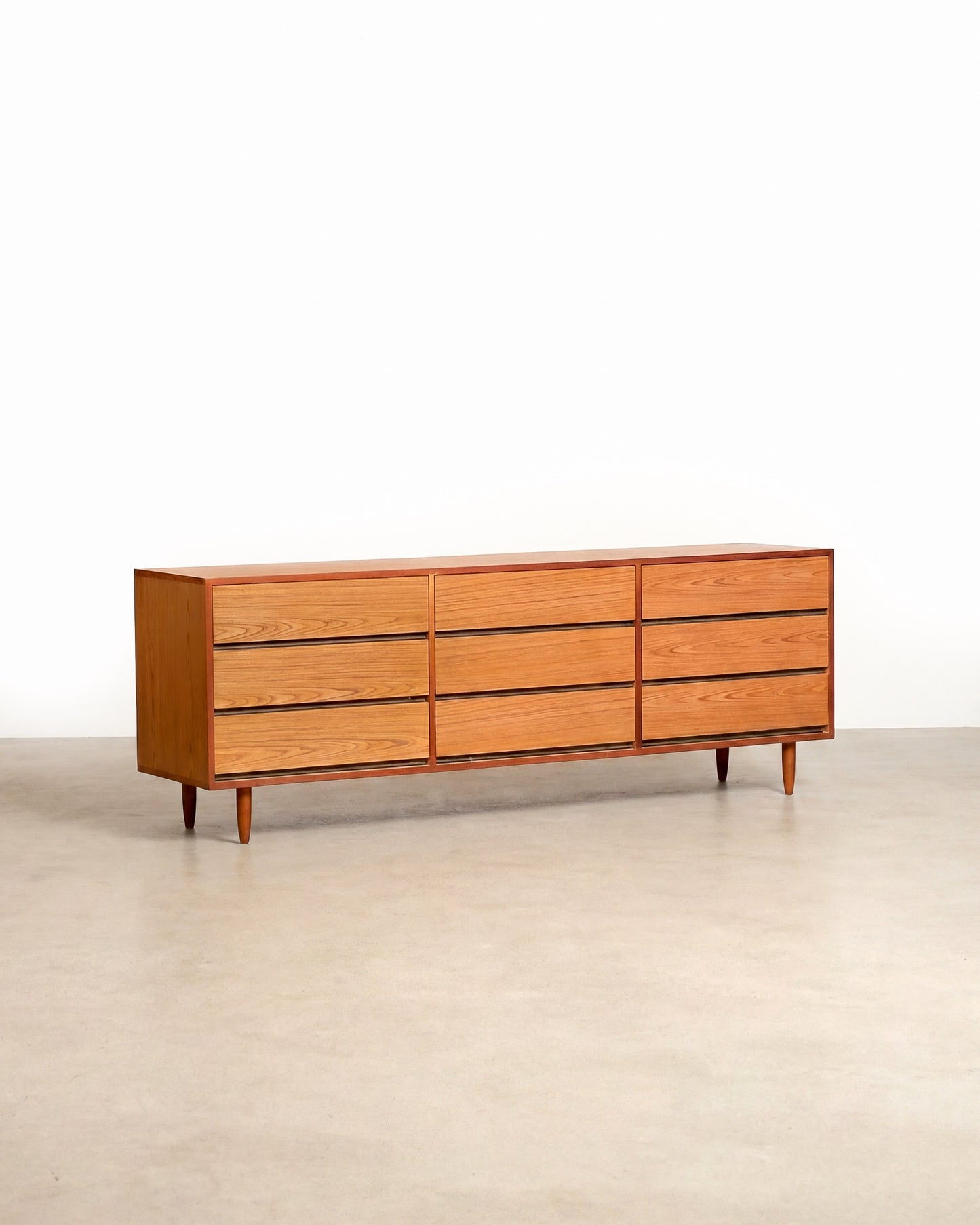 Wooden dresser with six drawers on a plain background