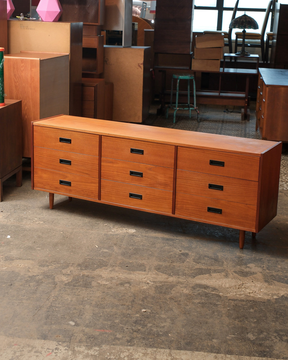 Mid-century modern teak 9-drawer dresser, angled view showing full length and tapered legs
